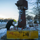 Michelle Filkins cleans up and lights candles at the Daunte Wright memorial after guilty verdicts were announced against former Brooklyn Police officer Kimberly Potter on Thursday, Dec. 23, 2021, in Brooklyn Center, Minn.